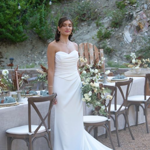 Bride standing in garden area vertical