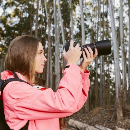 close-up-female-traveler-photographing-forest